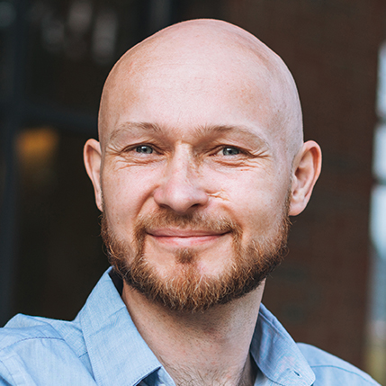 Adult bald smiling attractive man forty years with beard in blue