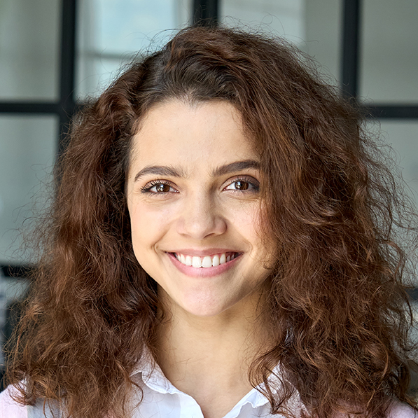 Latin Hispanic young female student standing looking at camera. Headshot.